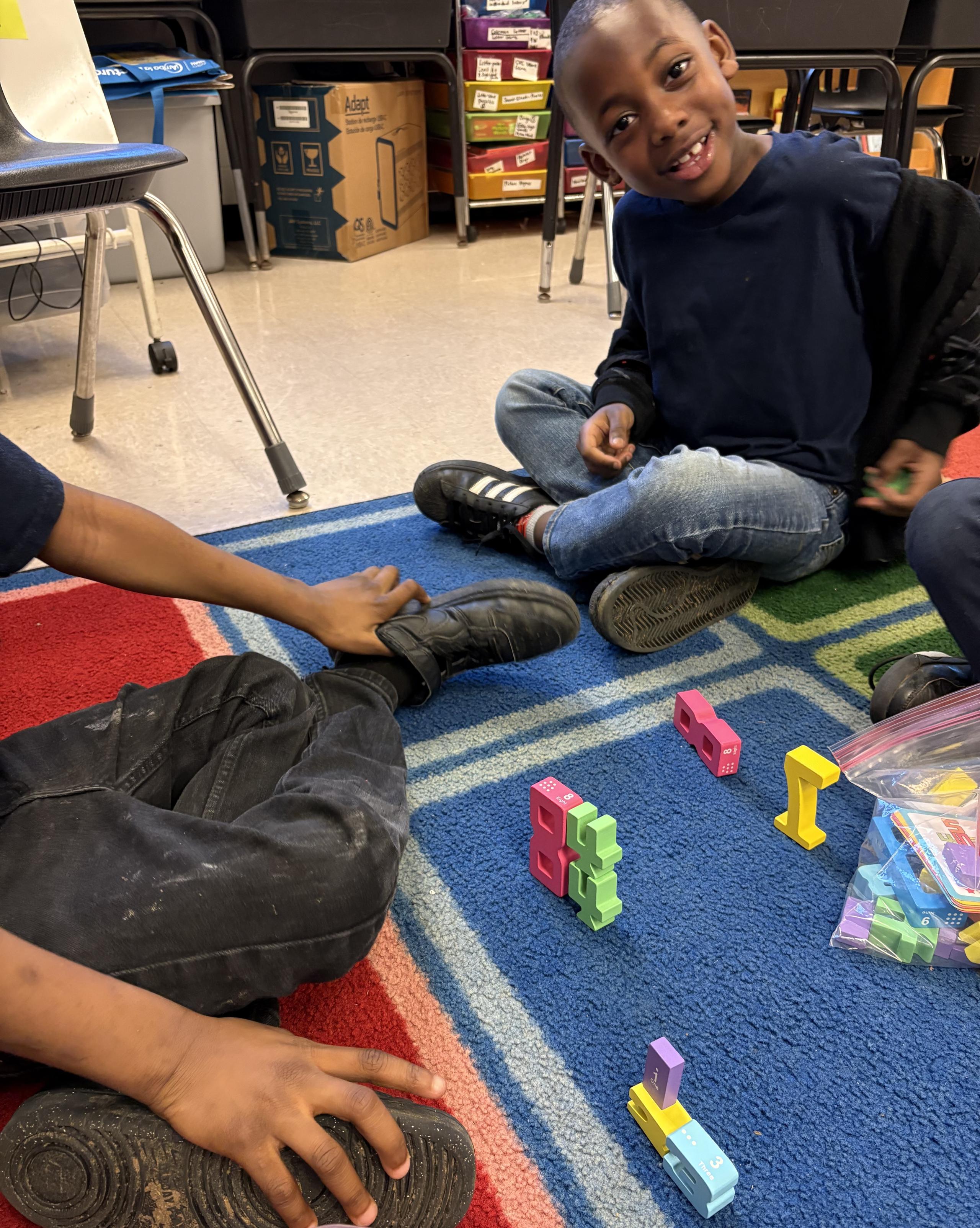 Student Smiling with Blocks