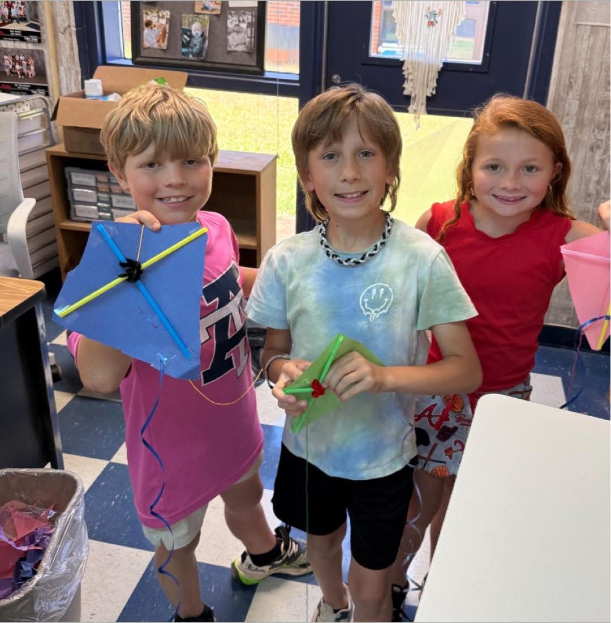 kids smiling with kites